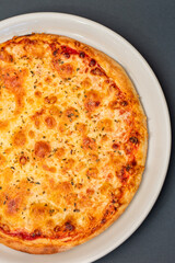 Italian pizza Margherita with cheese and tomato sauce grey background top view