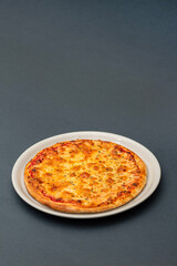 Italian pizza Margherita with cheese and tomato sauce grey background top view