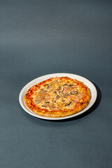 Homemade pizza with ham and mushrooms. A close shot of a pizza. Macro photo.Italian pizza capricciosa. Close-up
