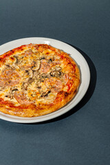 Homemade pizza with ham and mushrooms. A close shot of a pizza. Macro photo.Italian pizza capricciosa. Close-up
