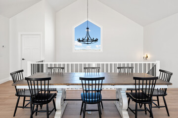 Large dining table with a chandelier hanging above it