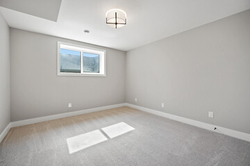 Very clean and empty room with a white wall and a window