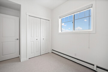 Bedroom with a white door and white walls