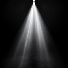 A single bright spotlight shining down in a dark room with visible light rays