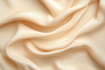 Fototapeta premium Cream-colored silk fabric drapes in flowing folds.