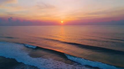 Obraz premium Majestic Sunset Over Calm Ocean Beach