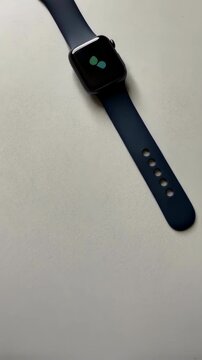 Black smart watch mockup on cream table modern vertical video