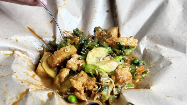 Rujak ulek. Indonesian salad, rice cake with various vegetables, peanut sauce and shrimp paste.