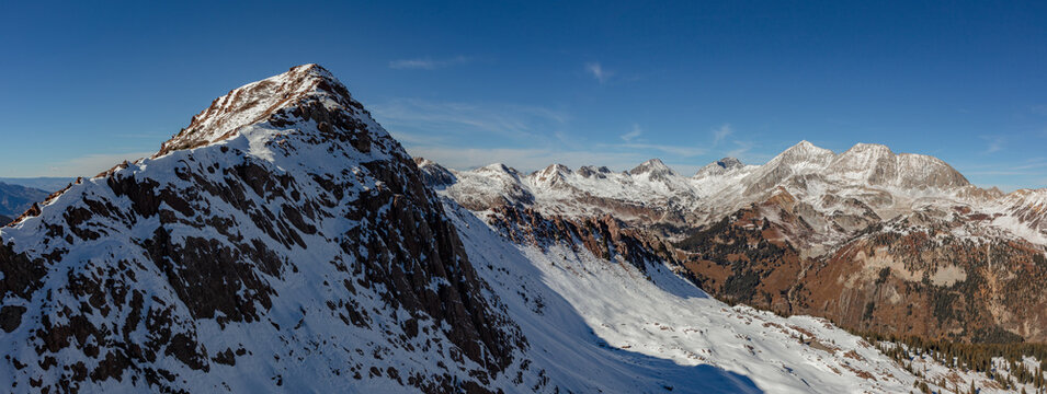 A ridge above Lead King Basin remains in shadow while Siberia Peak, Capitol Peak, Snowmass Mountain, and Haggerman Peak glow in the warm autumn sun.