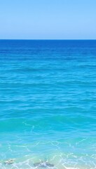 Obraz premium Serene blue ocean panorama, gentle waves lapping shore, open water, wide, view