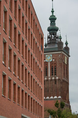 A large, impressive brick building with a clock prominently on top of it