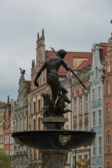 There is a beautiful fountain featuring a statue of a man perched atop it