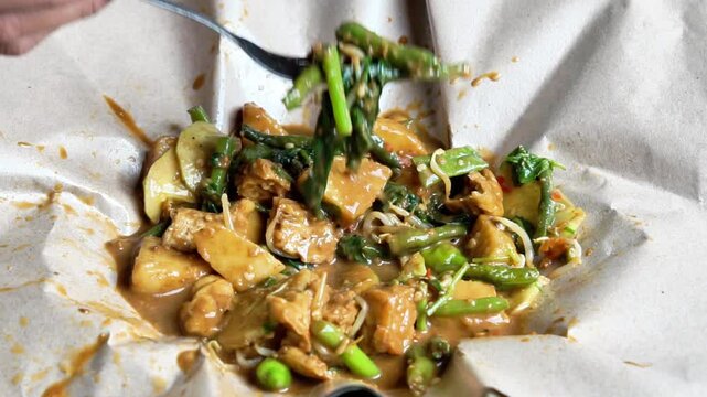 Rujak ulek. Indonesian salad, rice cake with various vegetables, peanut sauce and shrimp paste.