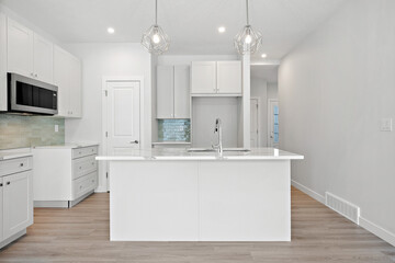Kitchen with a white island and a microwave above it