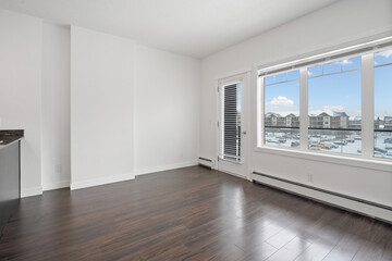 Large empty room with a window overlooking a city