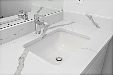 Sink with a silver faucet and a white porcelain basin