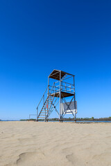 An old lifeguard tower on a deserted sandy beach
