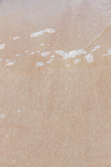 Ceannabeinne Beach shines under a clear summer sky. Crystal-clear waters, golden sand with a heart drawn on it, and lush green grass create a pristine and romantic coastal escape.