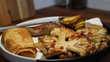 Grilled Cauliflower and Meat Meal on Plate – Homemade French Dinner Close-Up