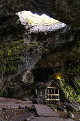 Smoo Cave in the Scottish Highlands captivates with its wide coastal opening and water-carved...