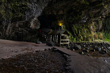 Smoo Cave in the Scottish Highlands captivates with its wide coastal opening and water-carved...