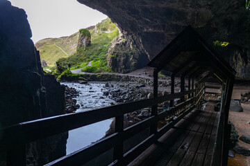 Smoo Cave in the Scottish Highlands captivates with its wide coastal opening and water-carved...