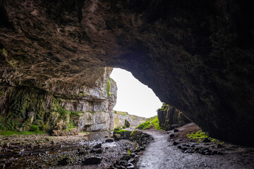Smoo Cave in the Scottish Highlands captivates with its wide coastal opening and water-carved...