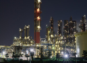 Industrial nightscape in Kawasaki, Japan with illuminated refinery towers