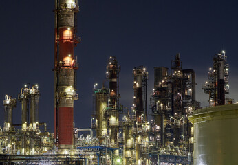 Industrial nightscape in Kawasaki, Japan with illuminated refinery towers