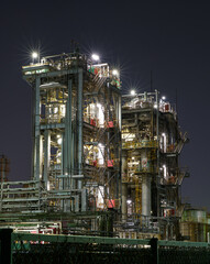 Industrial Structure at Night with Illuminated Stairs and Pipelines