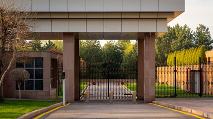Fototapeta premium Entrance to a Secure Facility with Gates and Greenery