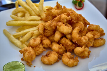 Peruvian Chicharrón de Calamar is a delightful dish featuring deep-fried calamari, often served as an appetizer or snack. It's known for its crispy texture and flavorful seasoning.