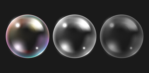 Three transparent spheres are aligned horizontally against a dark gray background. The leftmost sphere reflects iridescent colors, while the center and right spheres show varying degrees of gray
