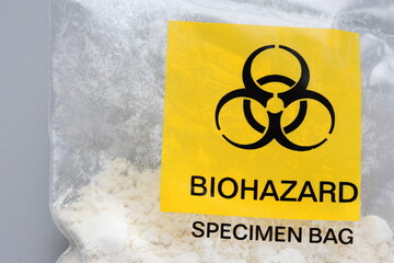 Biohazard plastic specimen bag. With white powder, concept photo.