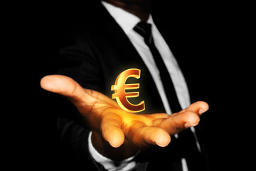 Black African businessman hand in suit and tie with 3D golden Euro sign symbol floating hovering in opened palm over black dark background