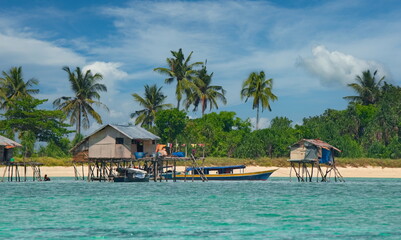 Malaysia. Coconut palms in the village of sea gypsies on numerous reef islands near the island of...