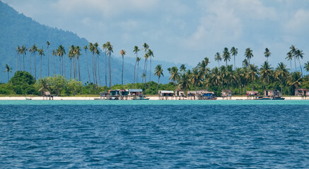 Malaysia. Coconut palms in the village of sea gypsies on numerous reef islands near the island of Borneo near the town of Semporna.
