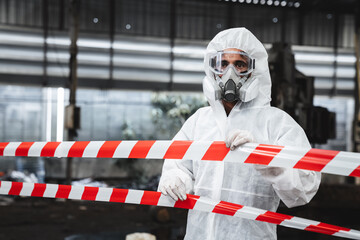 Fototapeta premium Workers in safety suits check chemicals in an old factory during a radiation emergency.