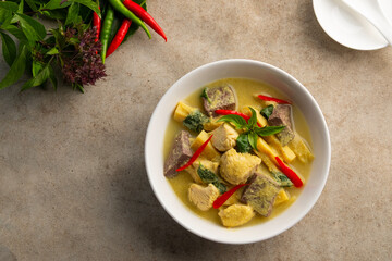 Thai healthy clean food,Green curry chicken breast and bamboo shoots in soybean milk in white bowl. Asian food.Top view copy space.