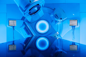Empty radiotherapy treatment room with linear accelerator ready for use. The clean, modern medical...