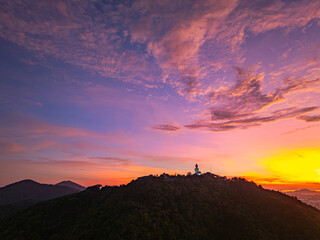 A breathtaking panoramic view of a vibrant sunrise casting warm hues over a coastal town, with the...