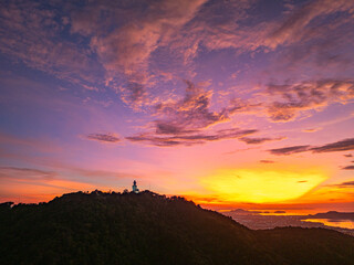 A breathtaking panoramic view of a vibrant sunrise casting warm hues over a coastal town, with the...