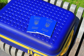 2 passports Ukraine citizens with inscription in Ukrainian - Passport of Ukraine lie on yellow blue...