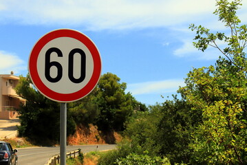 Traffic sign 60, Speed limit 60, on mountain road in Croatia Speed limit sign with traffic in background