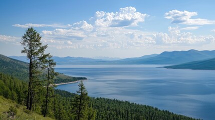 Expansive lake view with mountainous backdrop and pine forests.