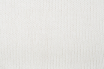 Sweater or scarf fabric texture large knitting. Knitted jersey background with a relief pattern. Wool hand- machine, handmade.