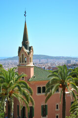 View of Gaudi House Museum from the Park G&uuml;ell in Barcelona with montjuic mountain in background. Vertical advertise with copyspace.