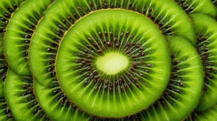 Close-up View of Vibrant Green Kiwi Slices Arranged in a Circular Pattern with Black Seeds and Shimmering Texture
