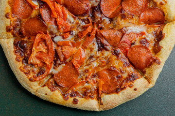 Delicious pepperoni pizza with melted cheese and fresh tomato topping