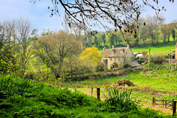 Quaint farmhouse in the beautiful countryside of the Cotswolds during spring, Gloucestershire,...